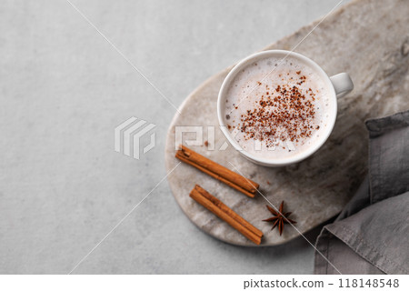 White mug of hot cocoa or chocolate with whipped cream, cinnamon sticks and star anise White mug of hot cocoa or chocolate with whipped cream, cinnamon sticks and star anise 118148548