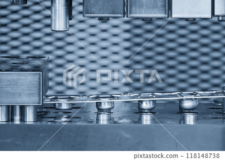 The  stamping operation of metal drawing process on the progressive die in the light blue scene. 118148738