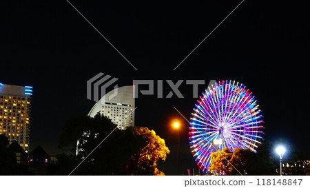 Moving walkway - Colorful illumination of the Ferris wheel "Cosmo Clock 21" 118148847