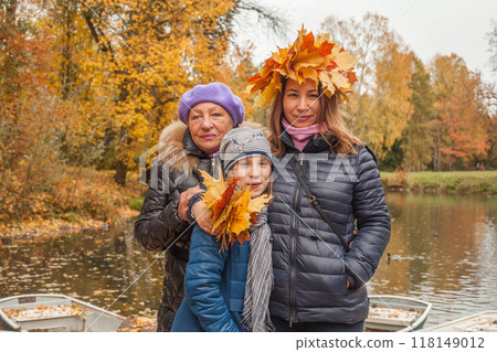 Autumn family outdoor. Grandmother, mother and daughter together Autumn family outdoor. Grandmother, mother and daughter together 118149012