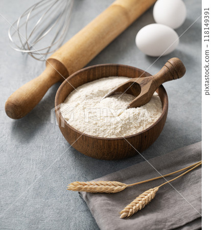 Ingredients for baking, flour, eggs, rolling pin and kitchen textiles on a blue background. Ingredients for baking, flour, eggs, rolling pin and kitchen textiles on a blue background. 118149391