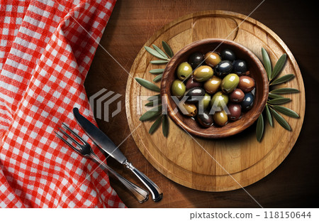 Olive Wooden Bowl Full of Fresh Olives above a Cutting Board - Generative Ai 118150644