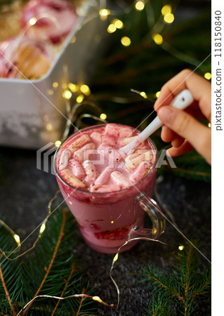 Festive Holiday Dessert Drink Topped With Marshmallows and Served in a Cozy Setting With Twinkling Lights 118150840
