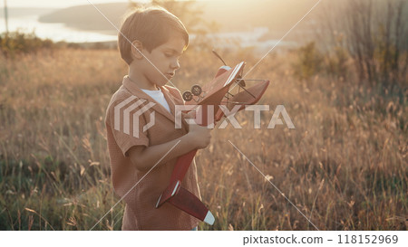 Curious 5 Years Old Preschool Child Boy Plays Craft Wooden Retro Styled Airplane Curious 5 Years Old Preschool Child Boy Plays Craft Wooden Retro Styled Airplane 118152969