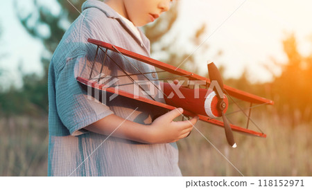 Curious 5 Years Old Preschool Child Boy Plays Craft Wooden Retro Styled Airplane 118152971