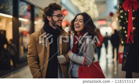 Happy young couple shopping during Christmas season at the shopping mall. 118153117