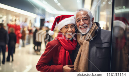 Happy elderly couple shopping during Christmas season at the shopping mall Happy elderly couple shopping during Christmas season at the shopping mall 118153134