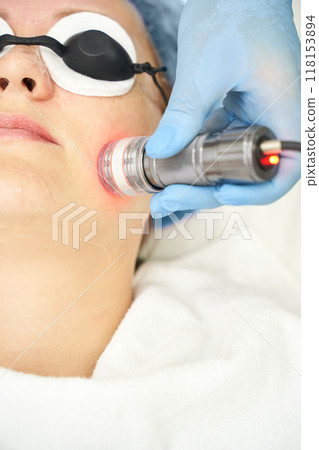 Light infrared therapy. Cosmetology head procedure. Beauty woman face. Cosmetic Light infrared therapy. Cosmetology head procedure. Beauty woman face. Cosmetic 118153894