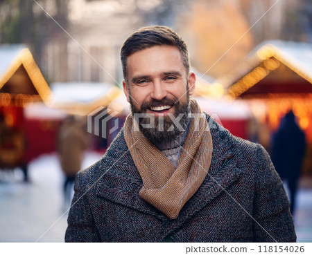 Winter Portrait of Happy Handsome Man Smiling Outdoors 118154026