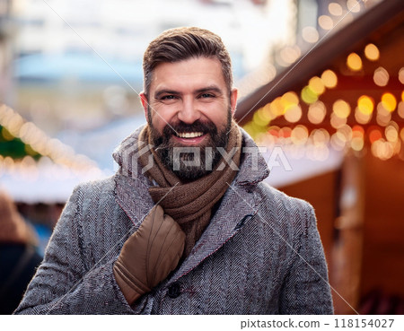 Winter Portrait of Happy Handsome Man Smiling Outdoors Winter Portrait of Happy Handsome Man Smiling Outdoors 118154027