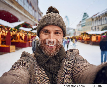 Winter Portrait of Happy Handsome Man Smiling Outdoors Winter Portrait of Happy Handsome Man Smiling Outdoors 118154028