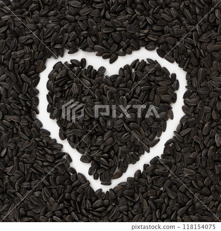 heart of black sunflower seeds on white background heart of black sunflower seeds on white background 118154075
