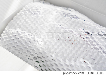 Corrugated white paper for safe transportation, in which the goods brought by the courier delivery service are wrapped, environmental packaging concept Corrugated white paper for safe transportation, in which the goods brought by the courier delivery service are wrapped, environmental packaging concept 118154106