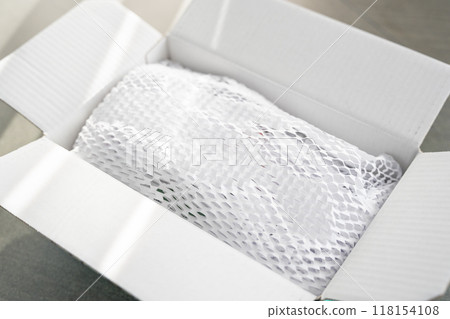 Corrugated white paper for safe transportation, in which the goods brought by the courier delivery service are wrapped, environmental packaging concept Corrugated white paper for safe transportation, in which the goods brought by the courier delivery service are wrapped, environmental packaging concept 118154108