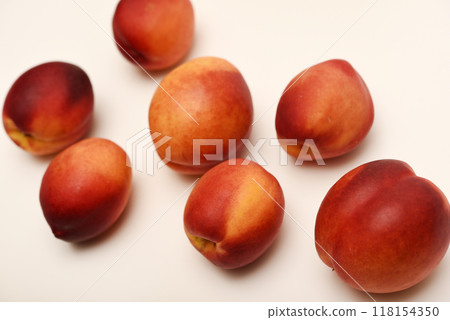 Juicy peaches on a white background. Ripe nectarines. 118154350