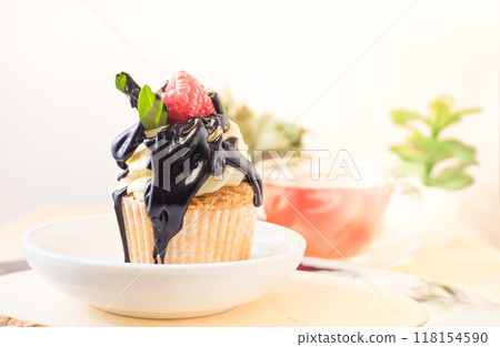 Cupcake with Cream, Chocolate Topping, and Raspberry 118154590