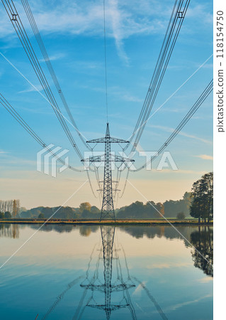 Power line in rural area with lake 118154750