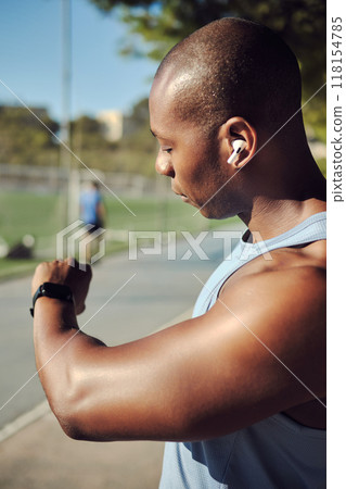 Young athletic man checking his smartwatch or fitness tracker Young athletic man checking his smartwatch or fitness tracker 118154785