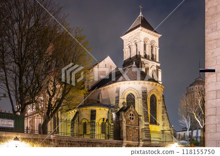The Church of Saint-Pierre de Montmartre is illuminated under the night sky, showcasing its architectural beauty in Paris, France. 118155750