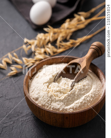 Organic baking ingredients. Oatmeal and eggs on a dark background close up. Organic baking ingredients. Oatmeal and eggs on a dark background close up. 118155814