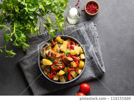 Fried pork meat with potatoes, onions and peppers. National homemade Georgian dish ojakhuri Fried pork meat with potatoes, onions and peppers. National homemade Georgian dish ojakhuri 118155880