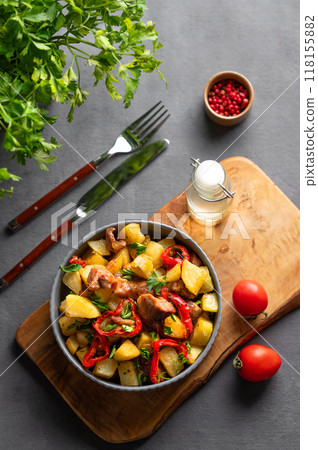 Fried pork meat with potatoes, onions and peppers. National homemade Georgian dish ojakhuri Fried pork meat with potatoes, onions and peppers. National homemade Georgian dish ojakhuri 118155882