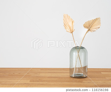 Stylish modern dry palm leaves in glass vase on a wooden background  in Scandinavian style. 118156198