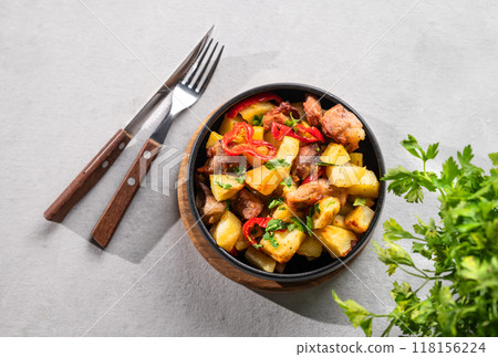 Fried pork meat with potatoes, onions and peppers. National homemade Georgian dish ojakhuri Fried pork meat with potatoes, onions and peppers. National homemade Georgian dish ojakhuri 118156224