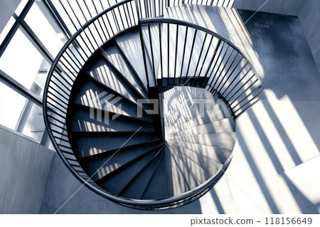 Modern spiral staircase made of concrete. Minimalist architecture with clean lines, contrasting light 118156649