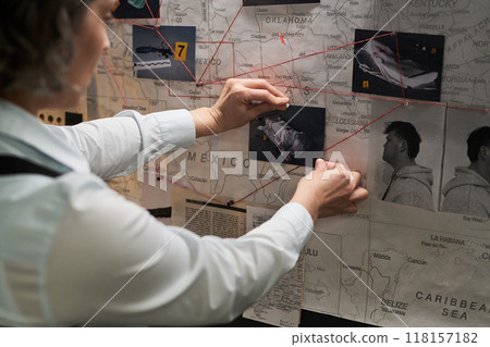 Analyzing Investigation Board With Crime Scene Photos 118157182