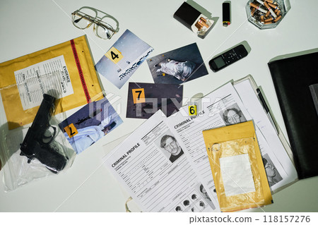 Investigating Crime Scene Evidence on Office Desk Setup Investigating Crime Scene Evidence on Office Desk Setup 118157276