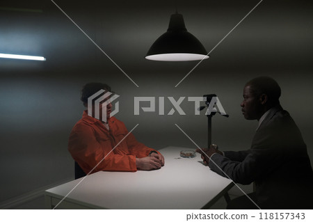 Interrogation Scene with Man in Orange Jumpsuit Interrogation Scene with Man in Orange Jumpsuit 118157343