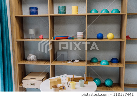 Rehabilitation therapy tools and equipment on shelves in a modern physiotherapy clinic setting Rehabilitation therapy tools and equipment on shelves in a modern physiotherapy clinic setting 118157441