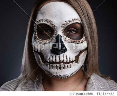 Woman in Skull and Bone Mask Day of the Dead Concept 118157752