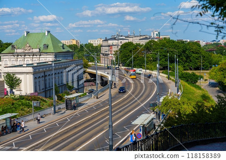 Cityscape of Warsaw with a tram passing by a historic building on a sunny day 118158389