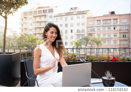Smiling female freelancer using laptop at outdoor 118158582