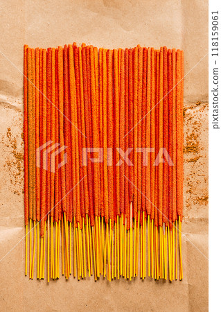 Orange incense sticks are neatly arranged on paper background. Relaxation and spirituality concepts. 118159061