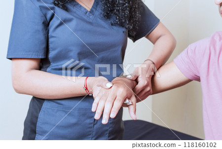Physiotherapist with patient wrist assessment, wrist rehabilitation physiotherapy, hand wrist assessment 118160102