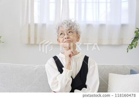Thinking senior woman living room 118160478
