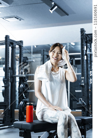 在健身房擦汗的年輕女子 在健身房擦汗的年輕女子 118160691
