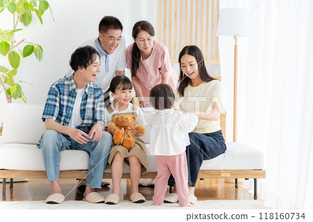 Three-generation family relaxing in the living room Three-generation family relaxing in the living room 118160734