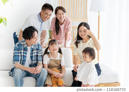 Three-generation family relaxing in the living room Three-generation family relaxing in the living room 118160735