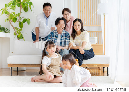 Three-generation family relaxing in the living room 118160736