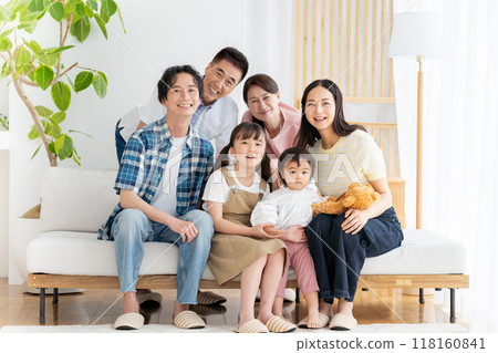 Three-generation family relaxing in the living room 118160841