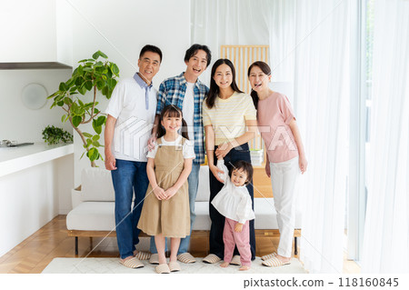 Three-generation family relaxing in the living room Three-generation family relaxing in the living room 118160845