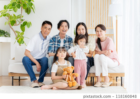 Three-generation family relaxing in the living room Three-generation family relaxing in the living room 118160848