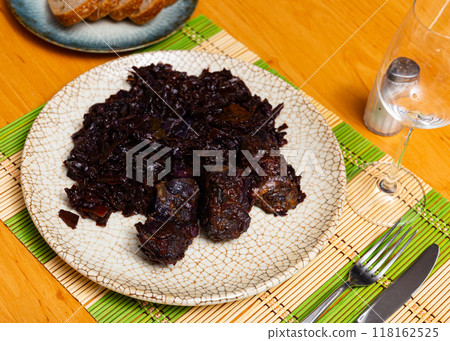 On plate there is stewed cabbage with delicious pork ribs 118162525