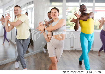 European girl with team of like-minded multinational people learn to elements of electro dance European girl with team of like-minded multinational people learn to elements of electro dance 118162789