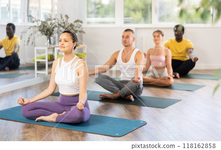 Asian woman meditating in Padmasana with hands in mudra in yoga class 118162858