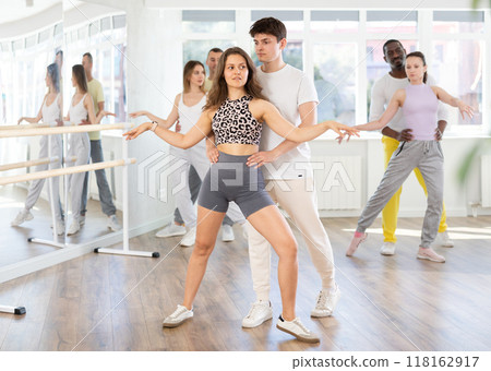 Young couple practicing passionate samba in dance class 118162917